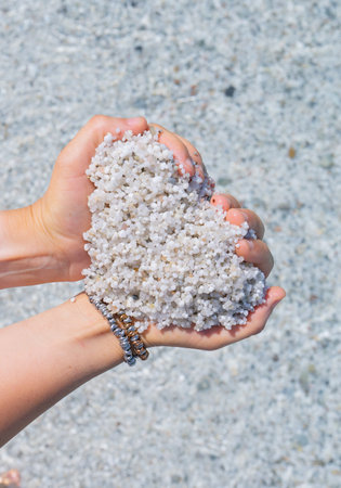 girl with white straw hat relaxes in front of the sea of ââââis arutas beach in central sardiniaの写真素材