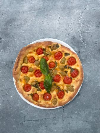 Bari style focaccia bread focaccia barese, focaccia with cherry tomatoes, olive oil and oreganoの写真素材
