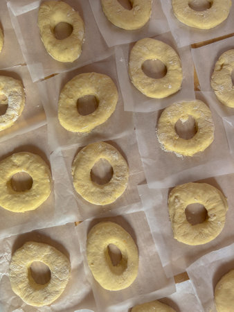 Freshly baked donuts on a baking sheet. Top views.の写真素材