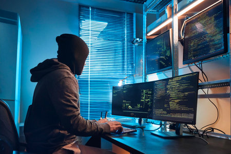 Hacker launching global cyberattack from laptop in server room, targeting world map networkの写真素材