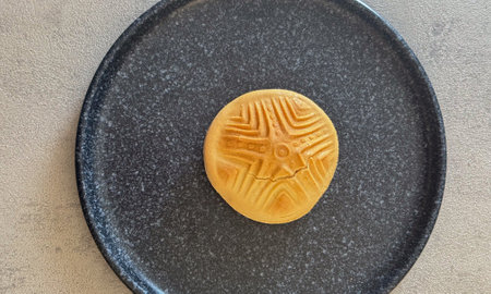 Traditional Sardinian bread with an ancient pintadera stamp design, symbolizing cultural heritage
