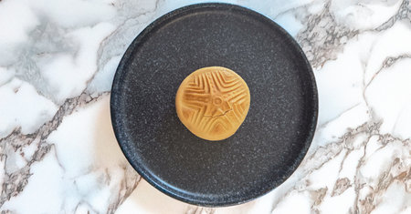 Traditional Sardinian bread with an ancient pintadera stamp design, symbolizing cultural heritage
