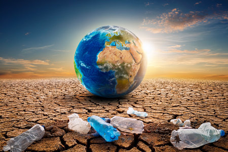 Planet Earth on cracked soil with Earth Day message, symbolizing climate change