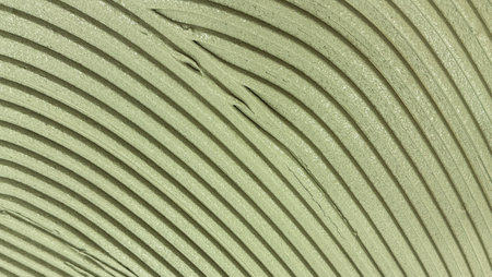 Textured surface with vertical beige lines and soft shadows, abstract architectural background