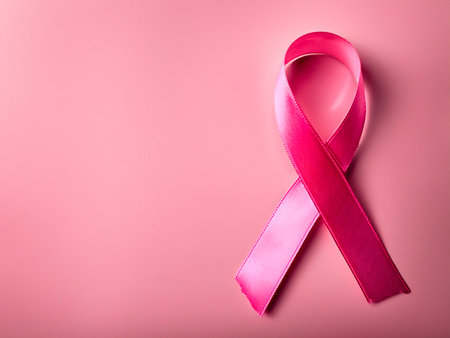 Close-up of doctor with pink ribbon for breast cancer awareness campaignの写真素材