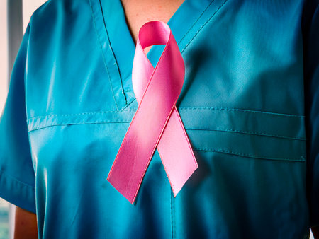 Close-up of doctor with pink ribbon for breast cancer awareness campaignの写真素材