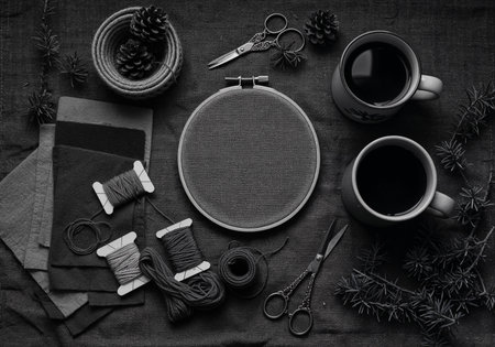 Top view of embroidery tools including hoops, colorful threads, scissors, and fabric swatchesの写真素材