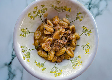Classic Sardinian pasta served with rich sausage ragÃ¹ in ceramic dishの写真素材