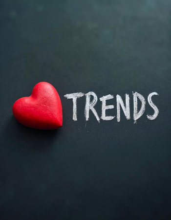 Red heart and chalk-written trends on blackboardの素材