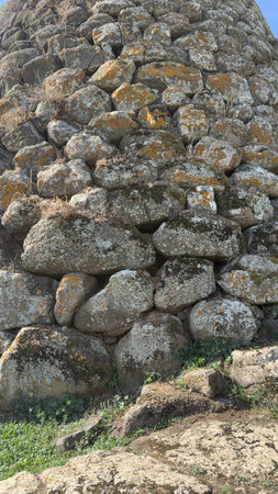 View of the Nuraghe Sa Jua archaeological site in Aidomaggiore, Sardinia, with basalt stones and surrounding countrysideの写真素材