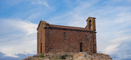 Ancient Church of San Saturnino in Benetutti Sardinia under cloudy skyの写真素材
