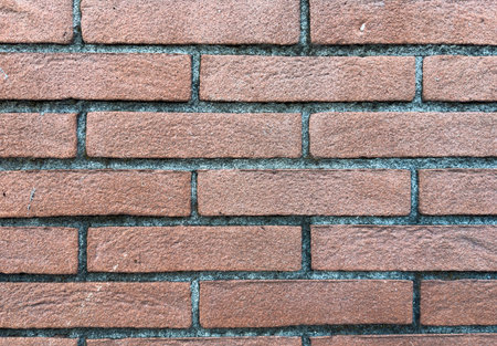 Detailed texture of red bricks and gray cement joints