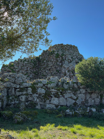 Nuraghe Arrubiu ancient megalithic wall and entrance in bright sunlightの写真素材