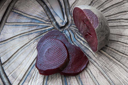 beets boiled on a textured cutting Boardの写真素材