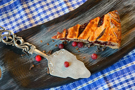Cranberry pie on a textured cutting Board 