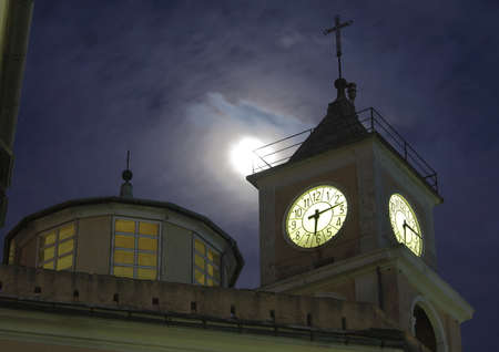 the bell tower and the moonの写真素材