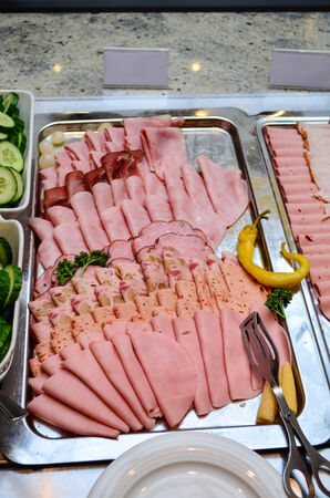 Delicious sliced salami served on a table in a metal trayの写真素材