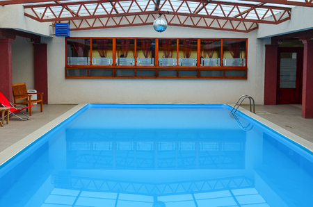 Empty indoor swimming pool, with clear, blue, tranquil waterのeditorial素材