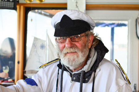 Portrait of old, experienced captain in his working surroundingの写真素材