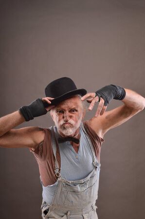 Old dirty beggar is angry, making scary faceの写真素材