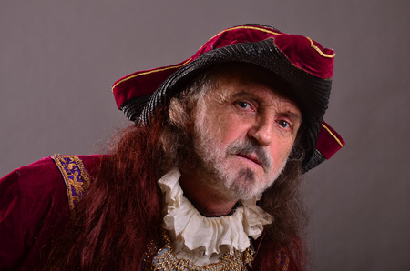 Old red head captain pirate shows curiosity, portrait, horizontal orientation, studio shotの写真素材