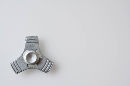 Silver fidget spinner over white background, lot of copy space on rightの写真素材