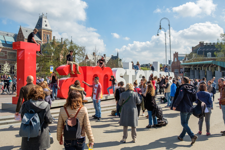 AMSTERDAM, The NETHERLANDS - APR 2, 2017 : Tourists climbing on the letters of the I Amsterdam sign at the Museum square in Amsterdamのeditorial素材