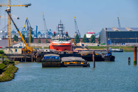Inland ships around sea ship to receive cargo. The Port of Rotterdam, the Netherlands.のeditorial素材