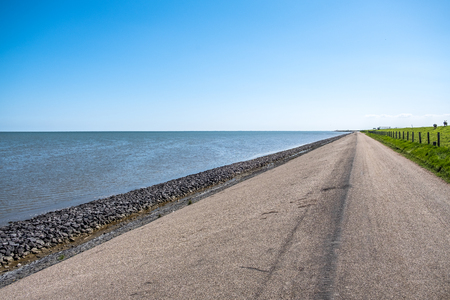 A long strengthened and high dyke along the east coast of the island of Texel, the Netherlands.の写真素材