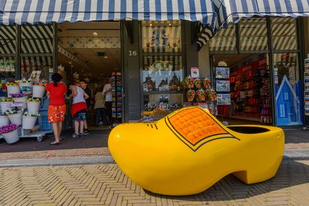 Souvenir shop with gigantic yellow clog in front of the shop window on the Grote Markt square in Delft, the Netherlands.のeditorial素材