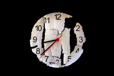 An abstract  old clock face, touched by time, on a black background