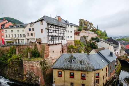 Autumnal view of the river Saar with water mills and colorful old houses in the historic town of Saarburg, Germanyのeditorial素材