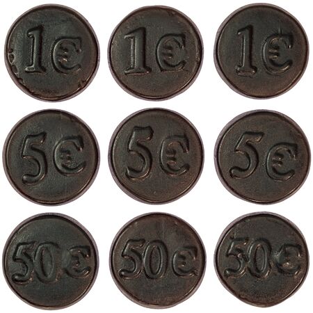 Nine black salty liquorice coins orderly arranged on a white background