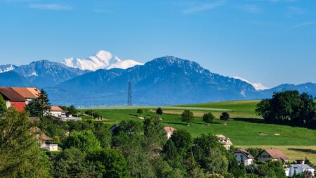 Beautiful view of the Mont Blanc massif in clear summer weather from a village near Lausanne in Switzerlandの写真素材