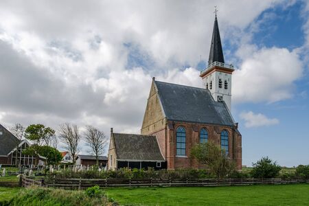 Dutch reformed church with cemetery next to the church in the village of den Hoorn, on the island of Texel, Netherlands. The church was build in the fifteenth centuryの写真素材