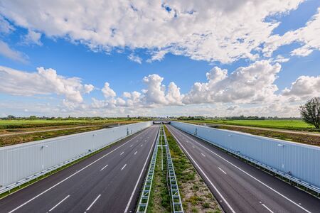 No traffic on this empty deserted modern deepened highway A4, The Hague - Rotterdam, Netherlands. This modern highway is built in a deepened location to save the Midden-Delfland nature reserve.の写真素材