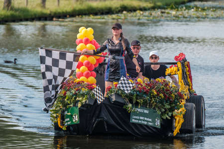 SCHIPLUIDEN, THE NETHERLANDS - JUN 23, 2022 : Annual colorful canal parade of flower and vegetables...