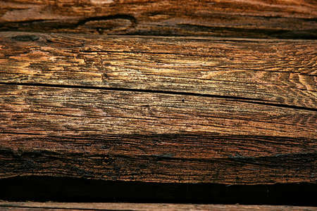 Background of wall of an old log house. Close-up shot dark vintage wood textureの写真素材