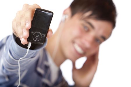 Teenager is listening to music with earphones and holding his mp3 player into camera. Focus on mp3 player.  Isolated on white.の写真素材