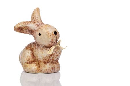 Small cute sitting ceramic easter bunny. Isolated on white backgroundの写真素材