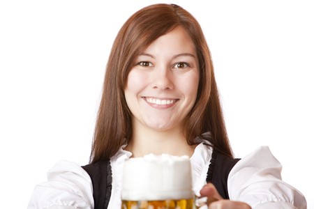 Happy smiling Bavarian woman in dirndl holding Oktoberfest beer stein. Isolated on white background.の写真素材