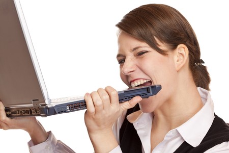 Frustrated stressed business woman bites in laptop. Isolated on white background.の写真素材
