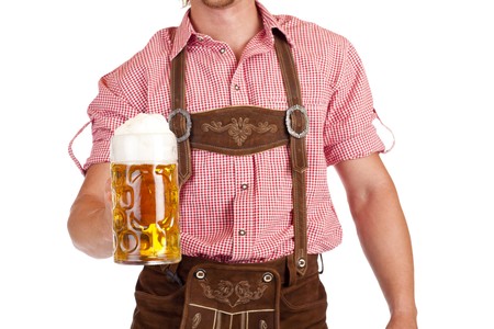 Bavarian man with leather trousers (Lederhose) holds Oktoberfest beer stein. Isolated on white background.の写真素材