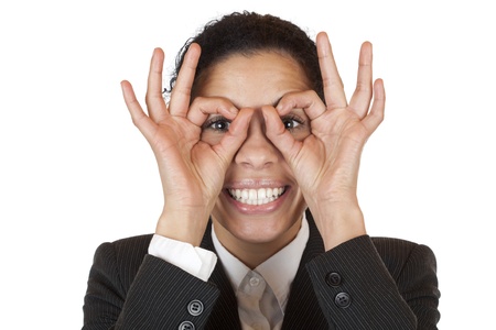 Woman looks through binoculars searching for business. Isolated on white background.の写真素材