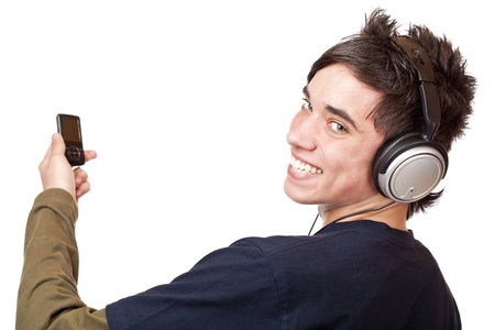 Teenager with headphone and mp3 player enjoys music. Isolated on white background.の写真素材
