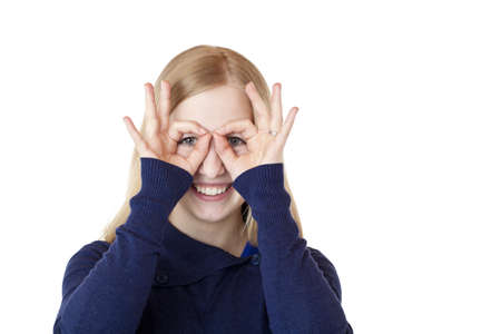 Young attractive woman shows with hands a binoculars. Isolated on white background.