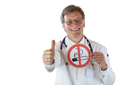 Happy smiling doctor holds smoking ban sign and shows thumb up. isolated on white background.