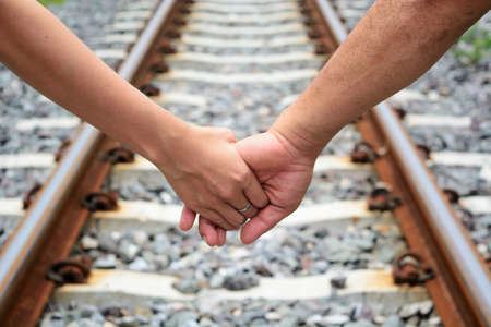 A couple walking along the train track.の写真素材