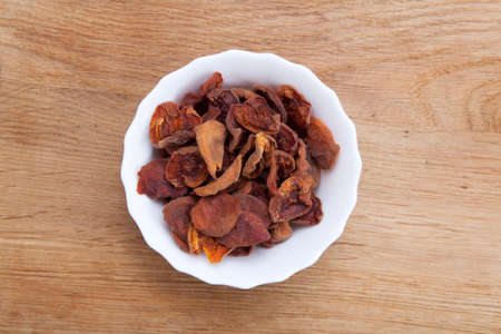 True sun dried organic apricots on wood backgroundの写真素材