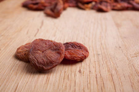 True sun dried organic apricots on wood backgroundの写真素材